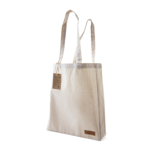 This cotton bag is made of 250 gram recycled cotton. The bag features a sewn-on "Recycle" label on one side. A hanging tag, which is fastened with hemp string, tells about the background of the bag and informs what our CSR work stands for.